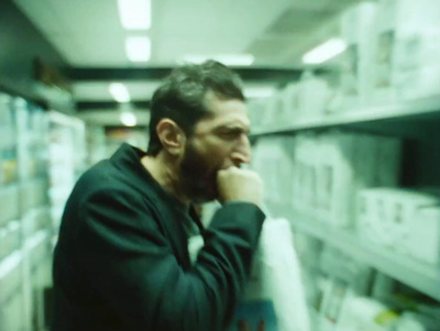 a man standing in a store with his hand on his chin