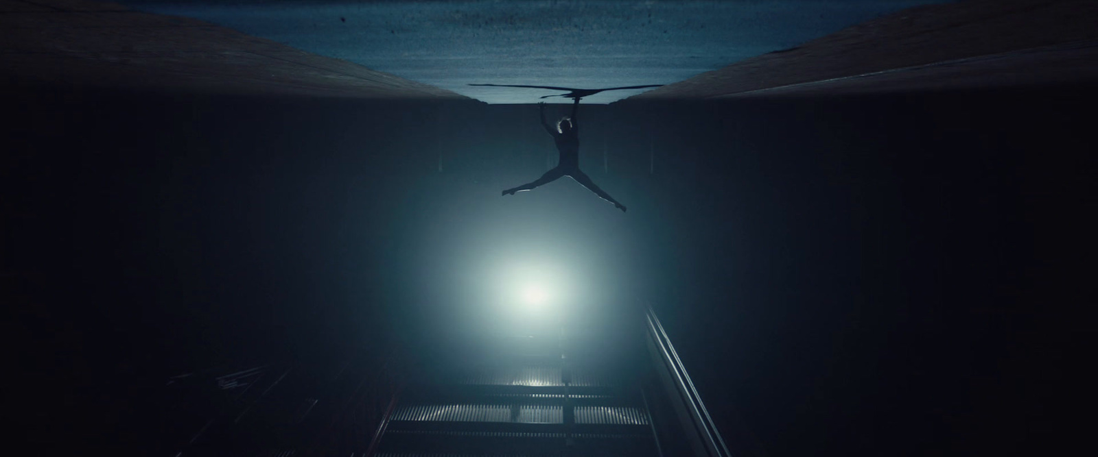 a person falling down a flight of stairs in the dark