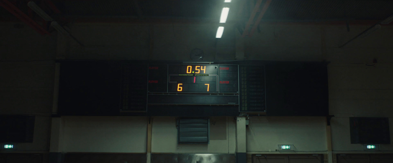 a basketball court with a scoreboard in the middle of it