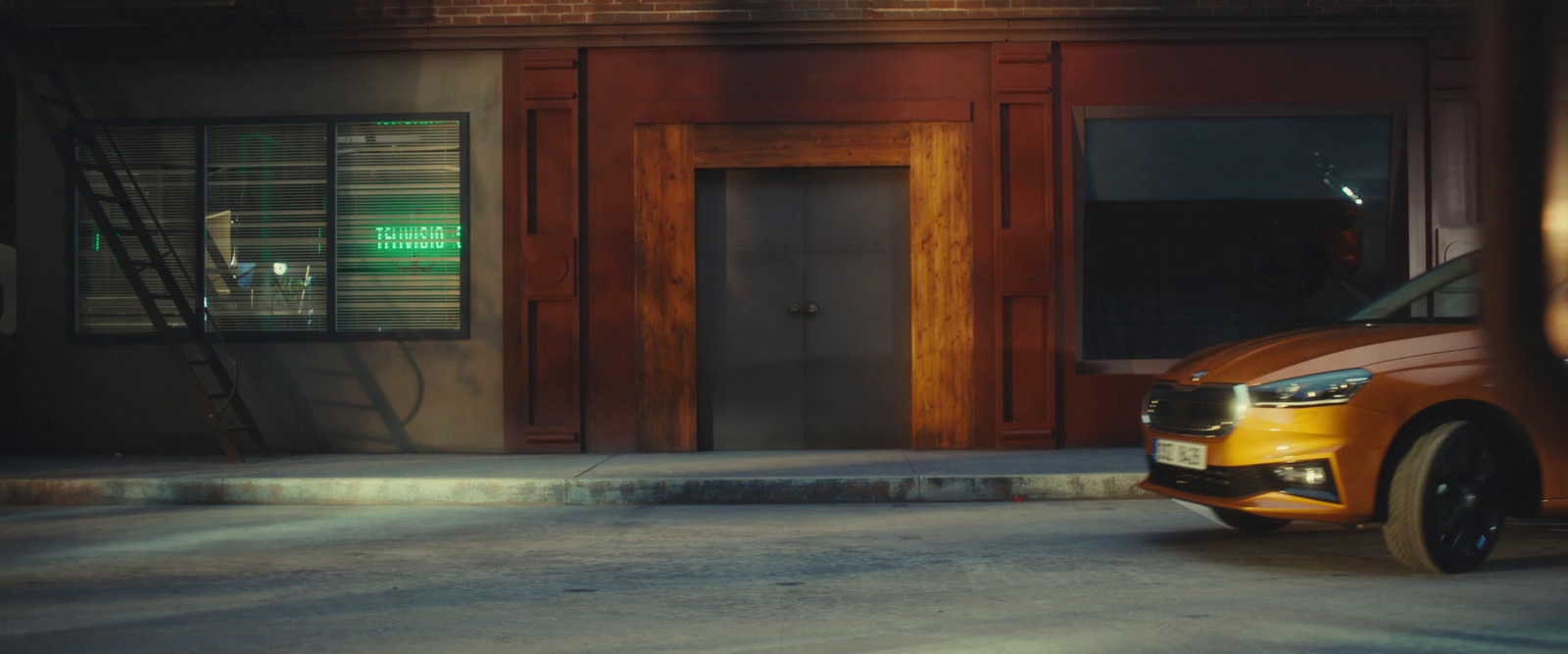 an orange car parked in front of a building