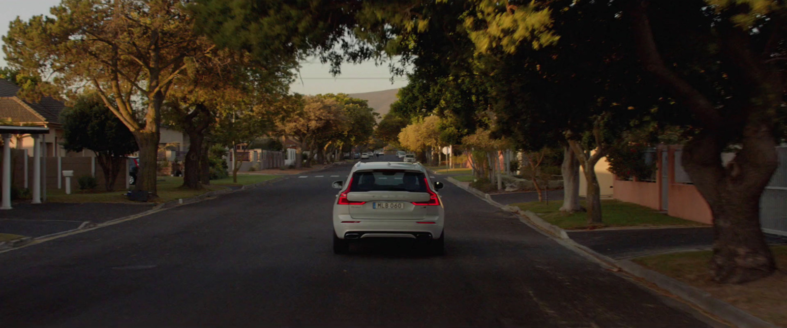 a white car parked on the side of a road