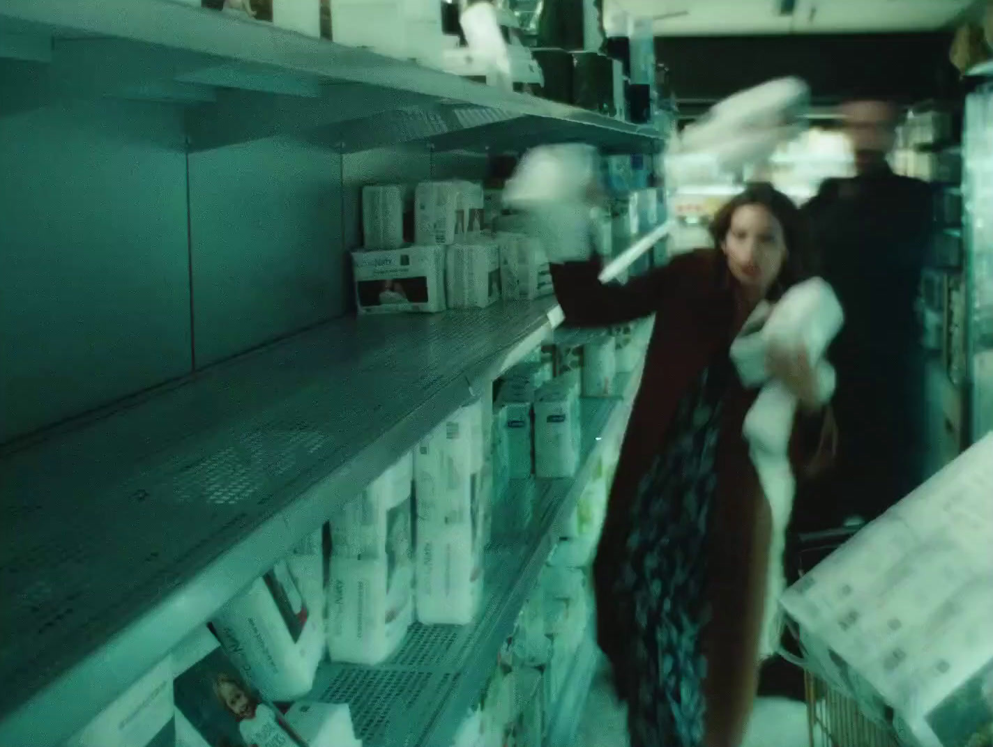 a woman standing in front of a shelf in a store