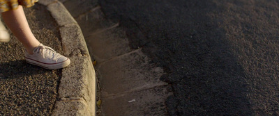 a person walking down a street with a skateboard