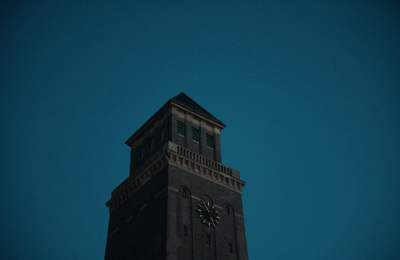 a tall clock tower with a clock on each of it's sides