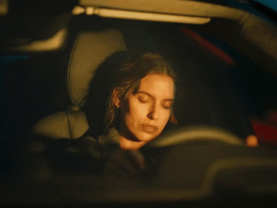 a woman sitting in the back seat of a car