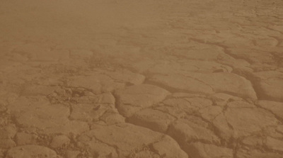 a plane flying over a barren desert landscape