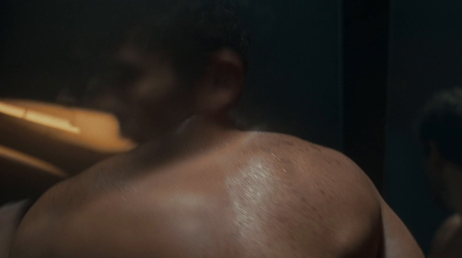 a blurry image of a man with no shirt on