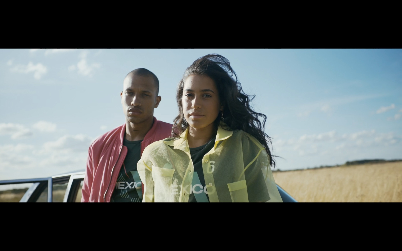 a man and a woman standing next to a truck