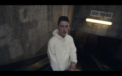 a man sitting on an escalator in a building