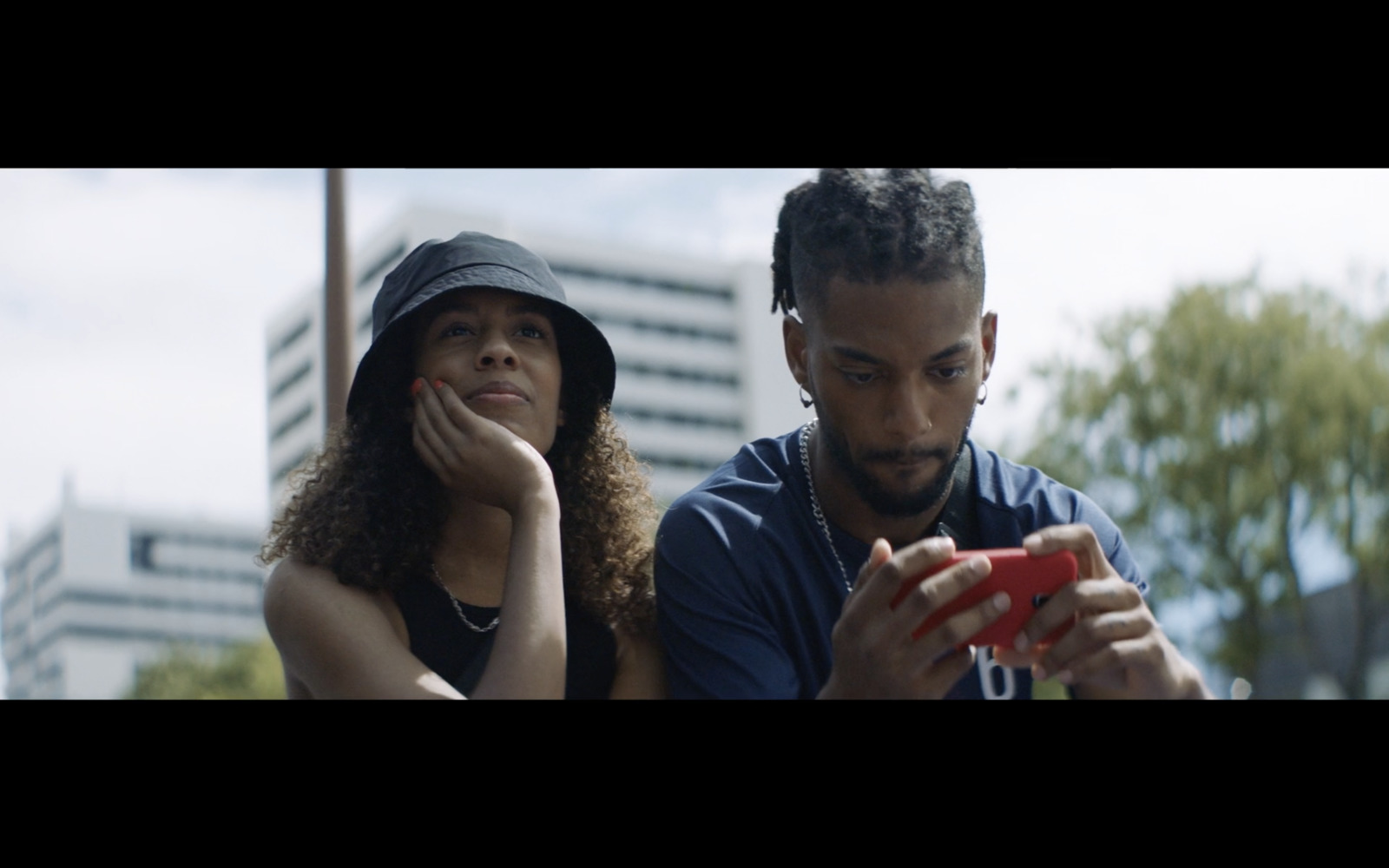 a man and a woman looking at a cell phone