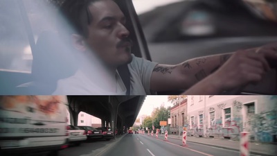 a man driving a car on a city street