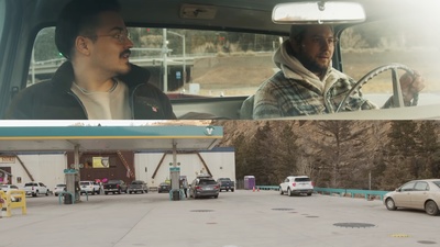 a man driving a car next to a gas station