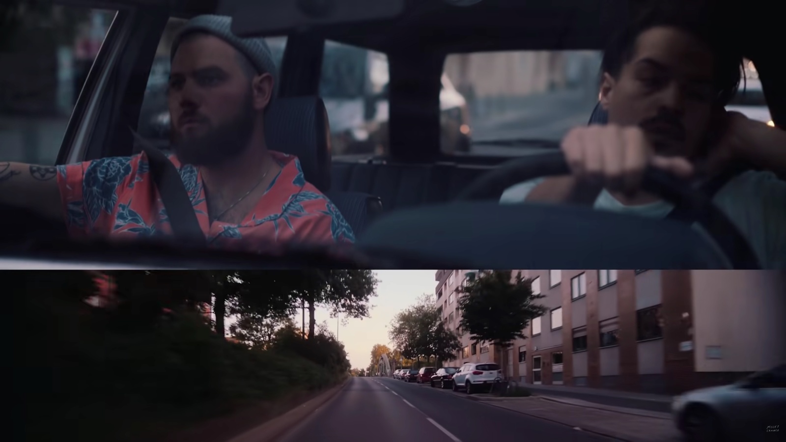 a man driving a car and another man driving a car