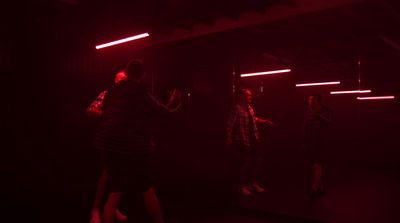 a group of people standing in a dark room