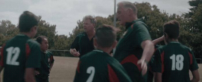 a group of men standing next to each other on a field