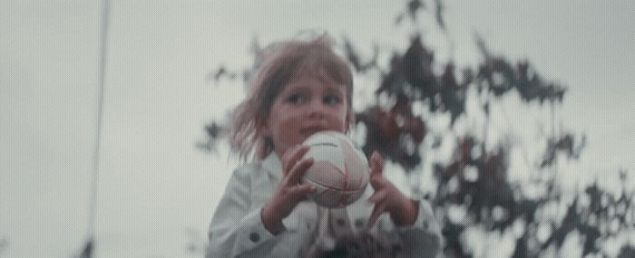 a young girl holding a white frisbee in her hands