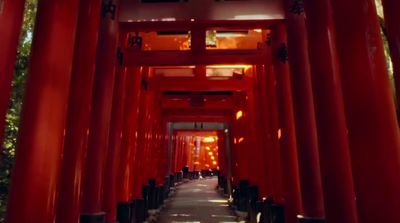 a walkway lined with red columns and lights