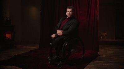 a man in a suit sitting in a chair