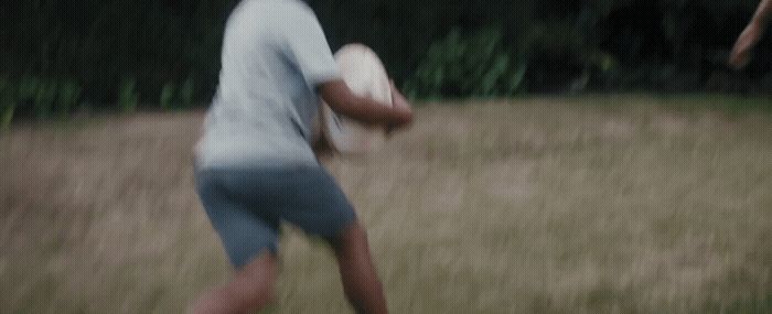 a blurry image of a man holding a frisbee