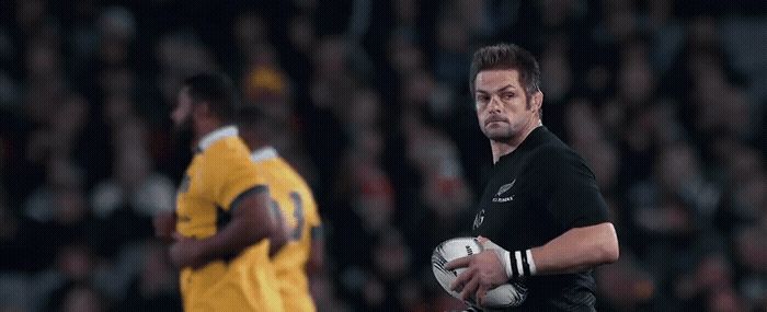 a man holding a soccer ball in front of a crowd