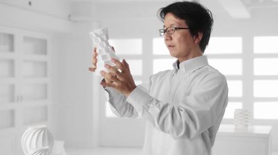 a man in a white shirt holding a white object