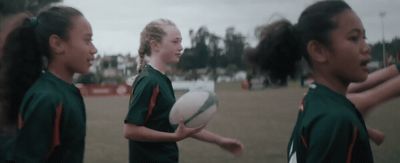 a group of young girls holding a white frisbee