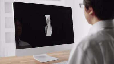 a man sitting in front of a computer monitor