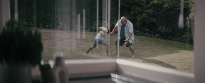 a man and a little girl playing with a frisbee