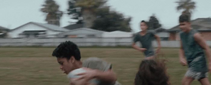 a group of young men playing a game of frisbee