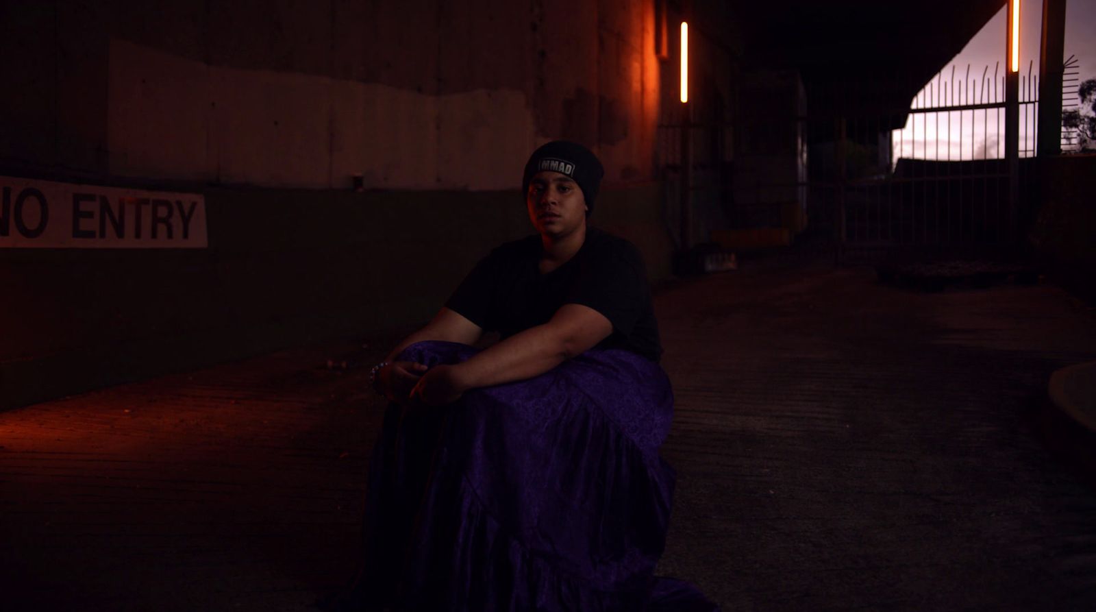 a man in a black shirt and a purple skirt