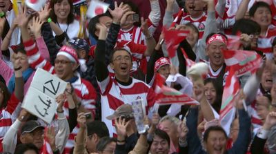 a crowd of people in red and white shirts