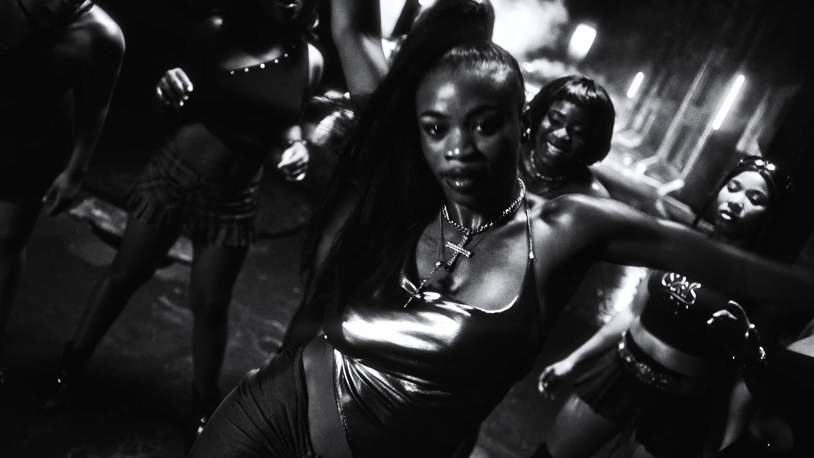 a black and white photo of a group of women dancing