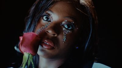 a close up of a person holding a rose