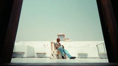 a man sitting in a chair on a tiled floor