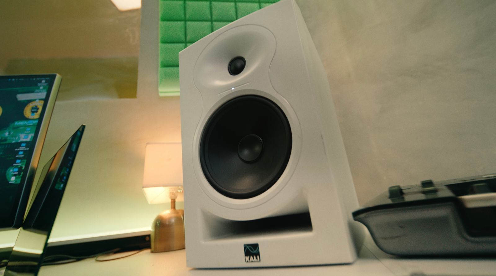 a white speaker sitting on top of a desk