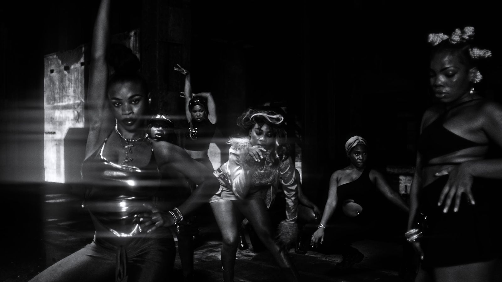 a black and white photo of a group of women dancing