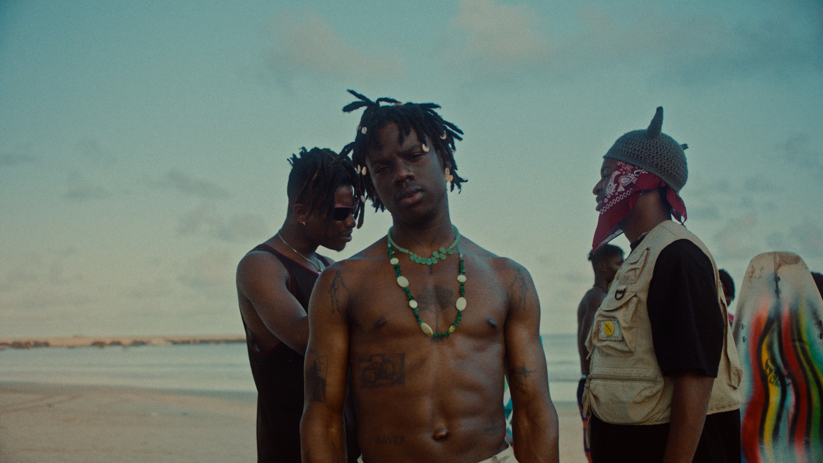 a group of men standing next to each other on a beach