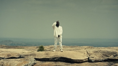 a man standing on top of a large rock