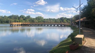 a large body of water with a bridge in the background