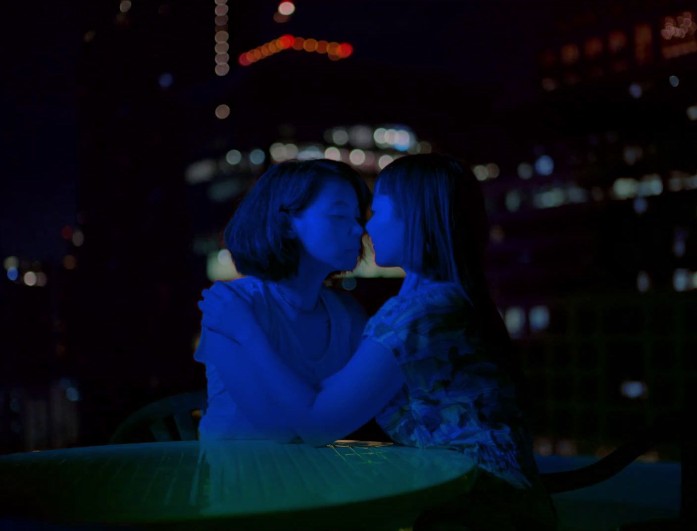 a couple of women sitting next to each other at a table