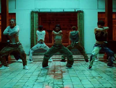 a group of young men standing on top of a tiled floor