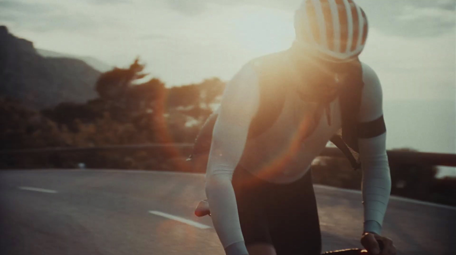 a man riding a skateboard down the side of a road