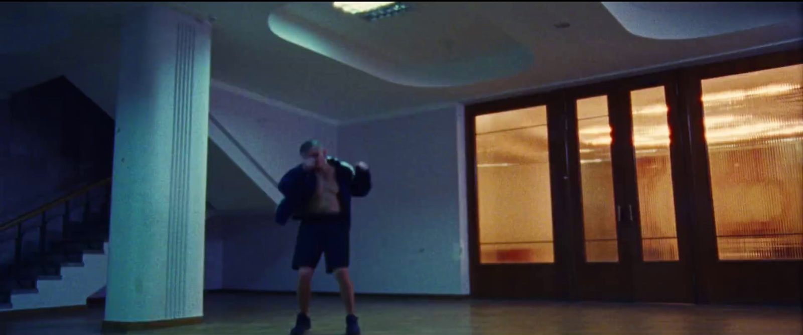 a man standing in a room with a punching bag