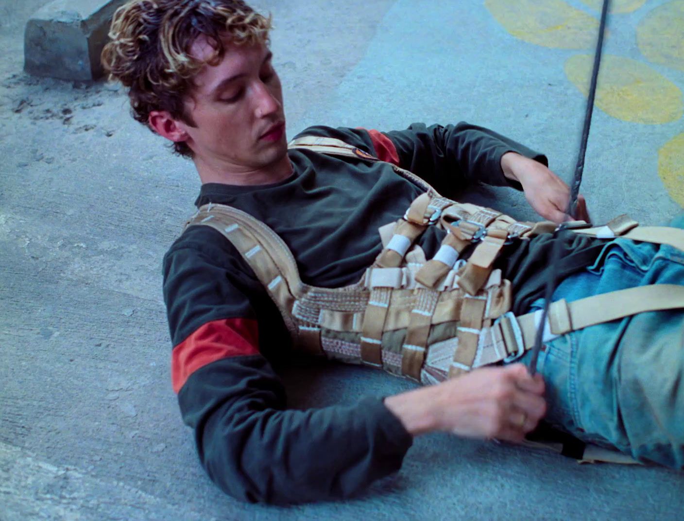 a man laying on the ground with an umbrella