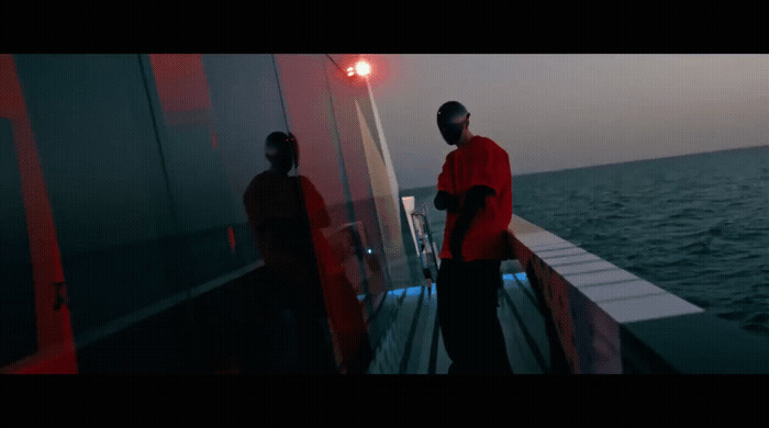 a couple of people standing on top of a boat