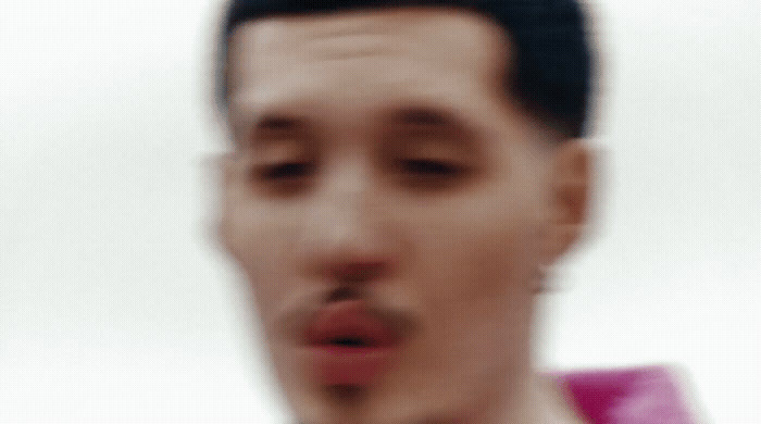 a blurry photo of a man making a face