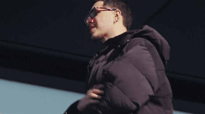 a man wearing a black jacket and sunglasses