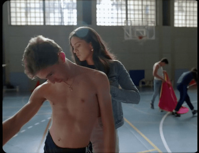 a couple of people that are standing in a gym