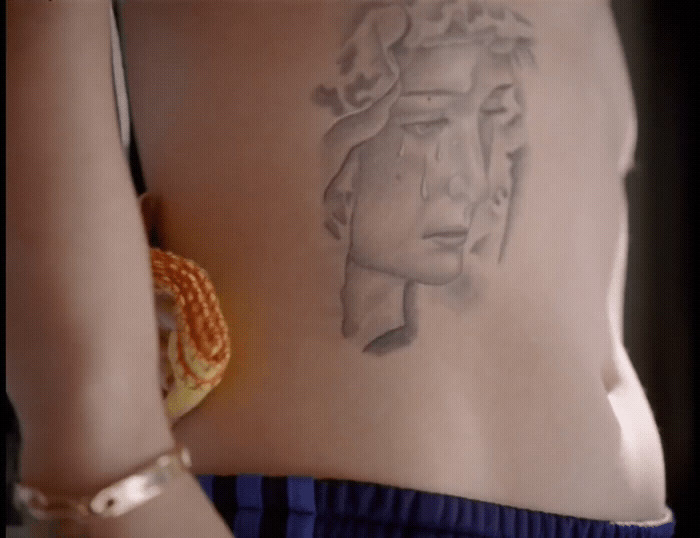 a woman with a tattoo on her stomach