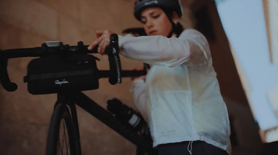 a woman in a white shirt and a bicycle